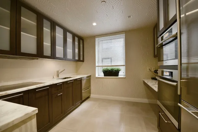 a kitchen with stainless steel appliances granite countertop a sink stove and cabinets