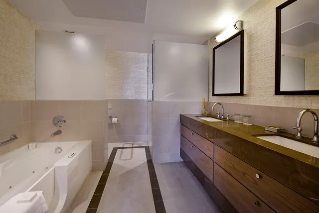 a bathroom with a tub sink and mirror