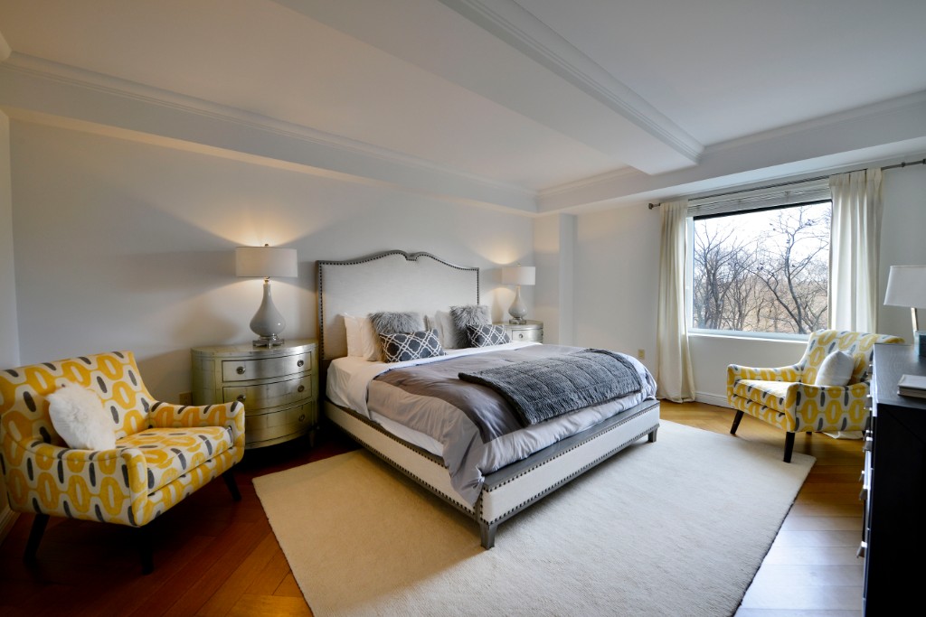 160 Central Park South, Unit 414 Manhattan, NY 10019 - Photo 8 of 12 a bedroom with a bed and wooden floor