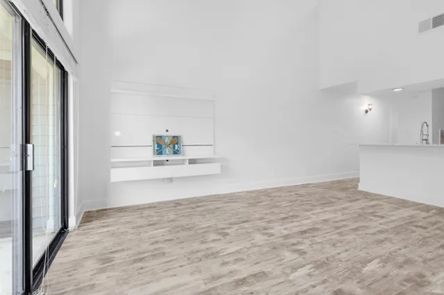 a view of kitchen and empty room