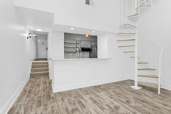 a view of a kitchen cabinets and wooden floor