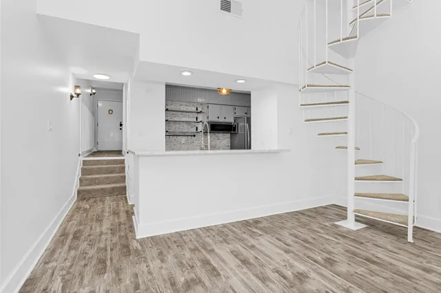 a view of a kitchen cabinets and wooden floor