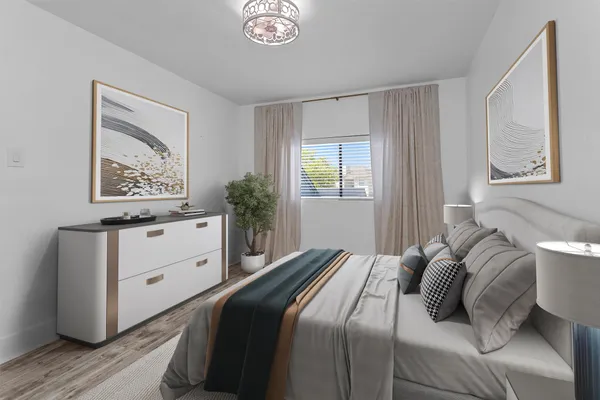 a bedroom with a bed and a window