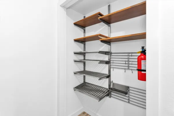 a view of storage and utility room with two washing machine