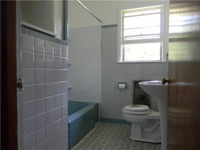 5049 Pickering Road Clarksville, TN 37043 - Photo 9 of 19 Classic hall bath, old fashioned steel tub, built in shelving.