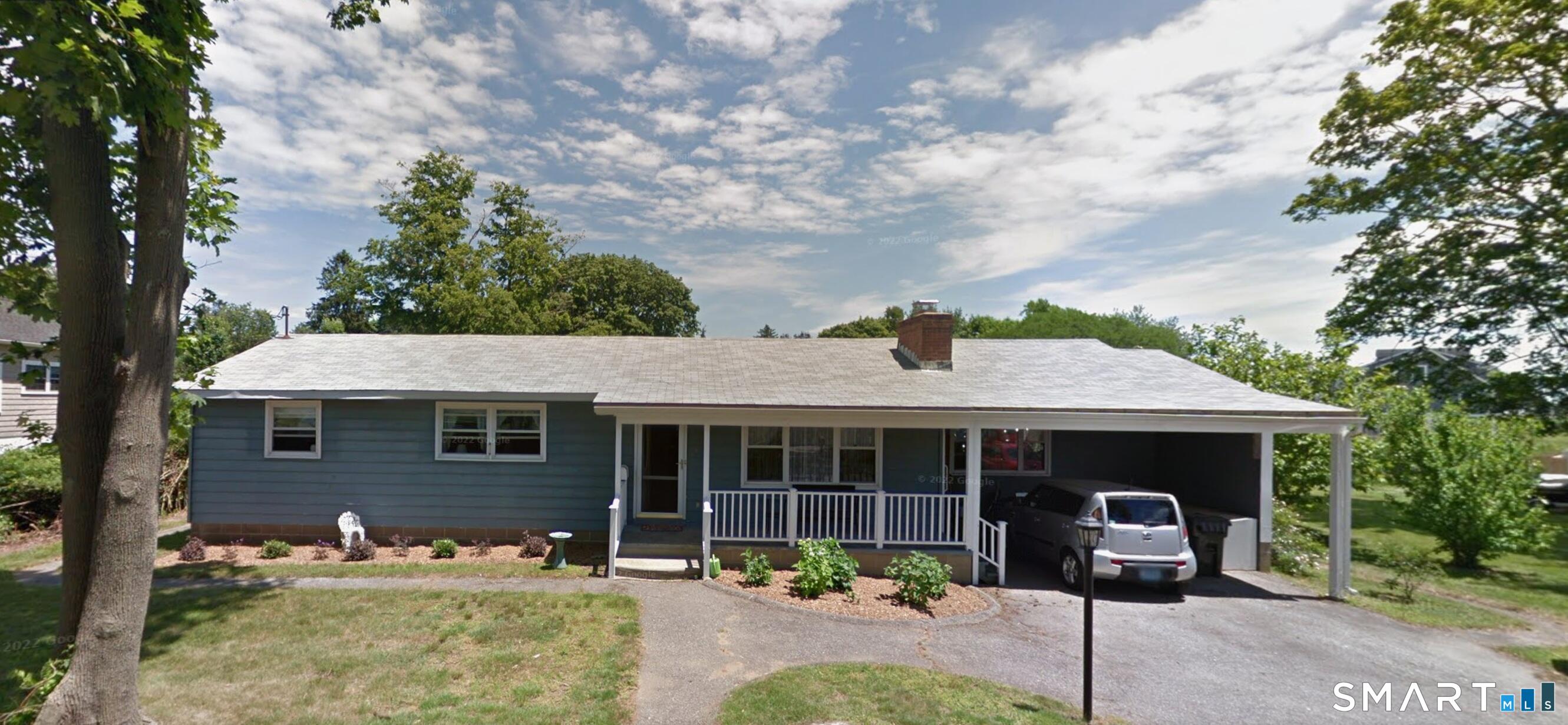 a front view of a house with garden and patio