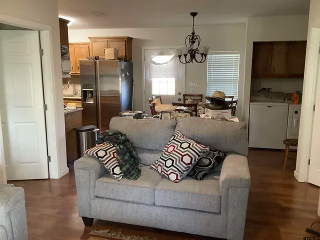 a living room with furniture and wooden floor