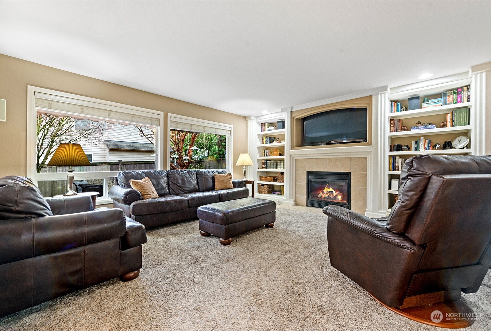 3930 208th Place Southeast Bothell, WA 98021 - Photo 13 of 36 a living room with furniture a flat screen tv and a fireplace
