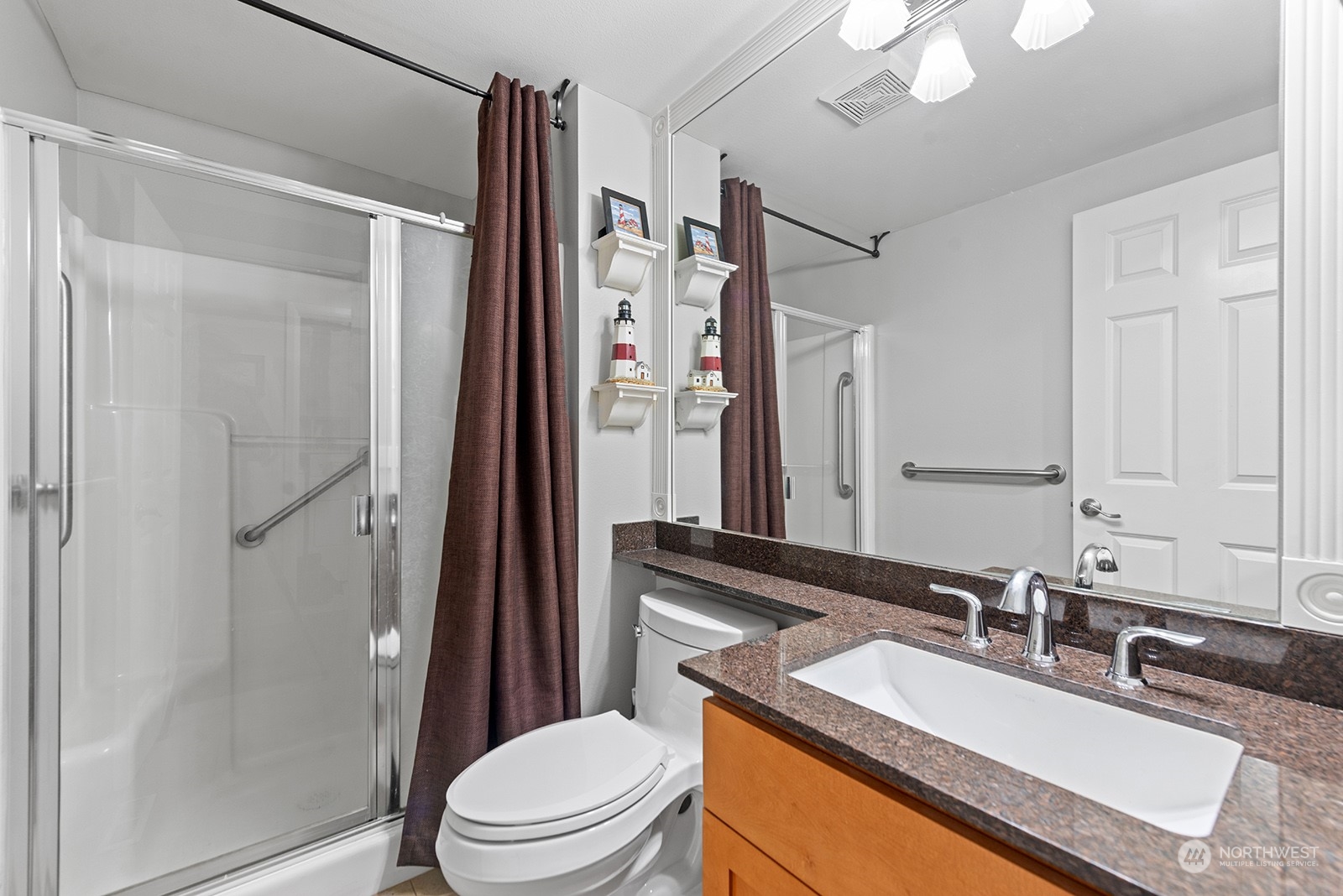 3930 208th Place Southeast Bothell, WA 98021 - Photo 17 of 36 a bathroom with a granite countertop sink toilet a mirror a vanity and shower