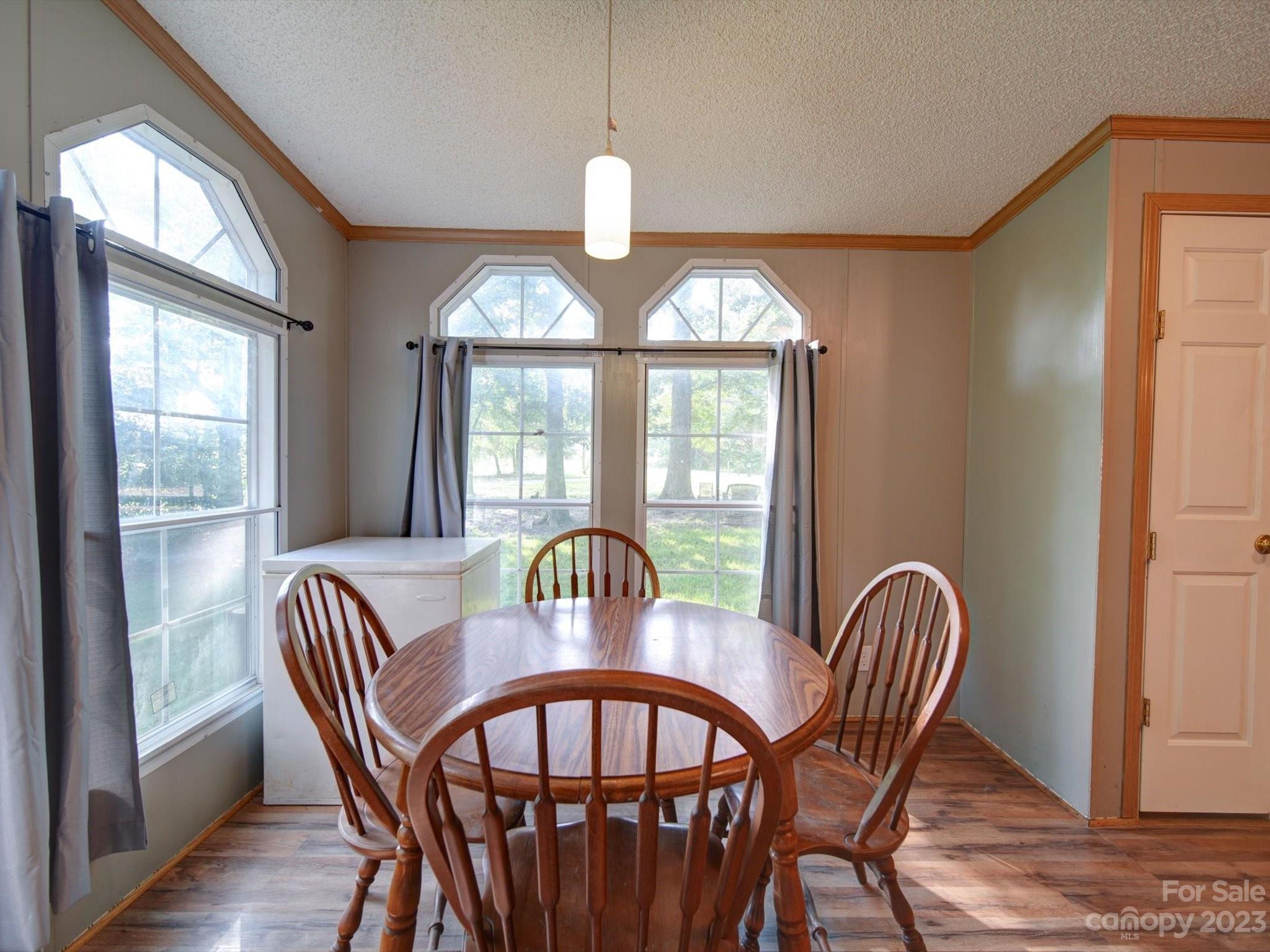 1265 Polk Ford Road Stanfield, NC 28163 - Photo 13 of 40 a view of a dining room with furniture window and wooden floor