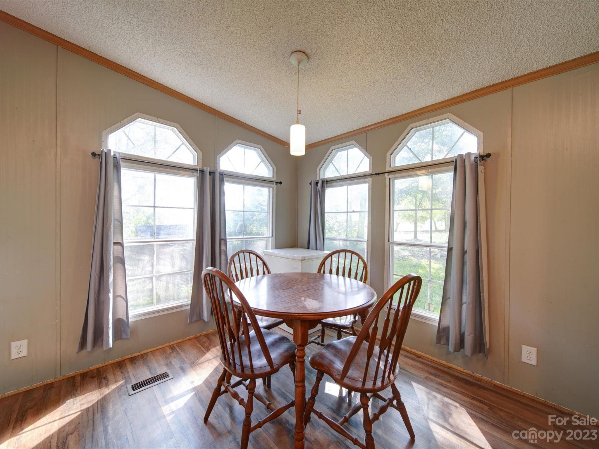 1265 Polk Ford Road Stanfield, NC 28163 - Photo 14 of 40 a dining room with furniture a chandelier and wooden floor