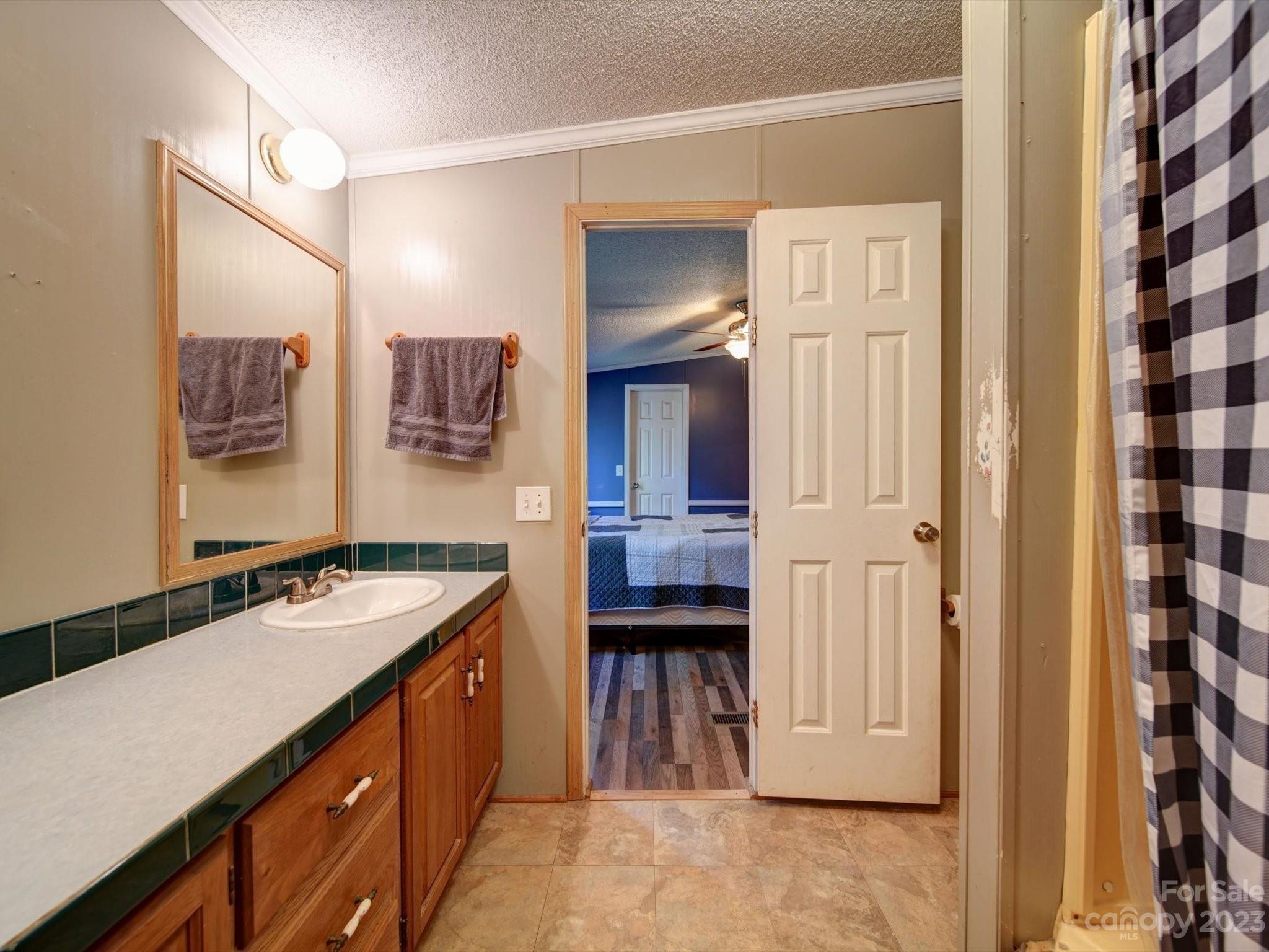 1265 Polk Ford Road Stanfield, NC 28163 - Photo 21 of 40 a bathroom with a sink double vanity and a mirror