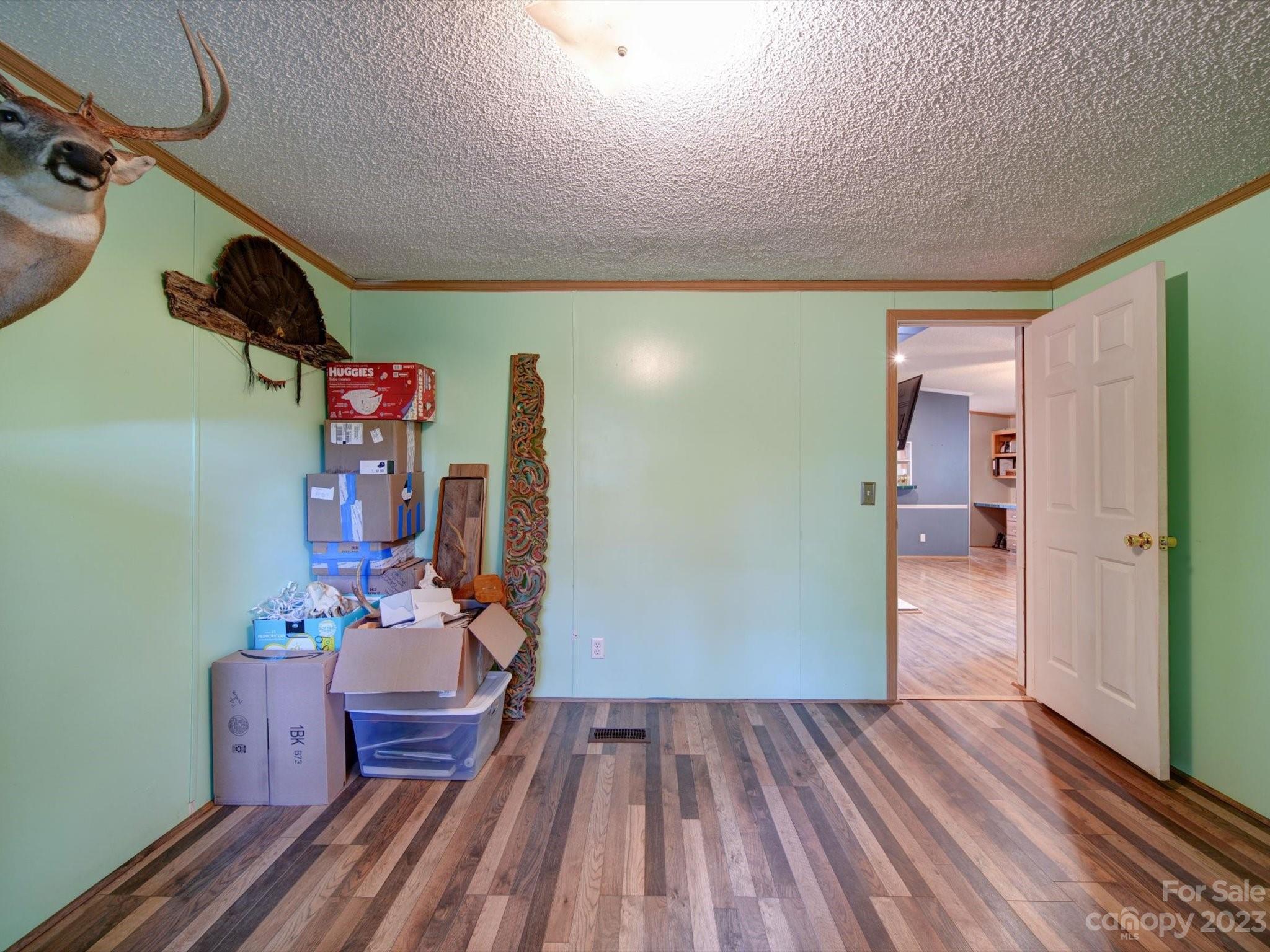 1265 Polk Ford Road Stanfield, NC 28163 - Photo 25 of 40 a bedroom with a bed and wooden floor