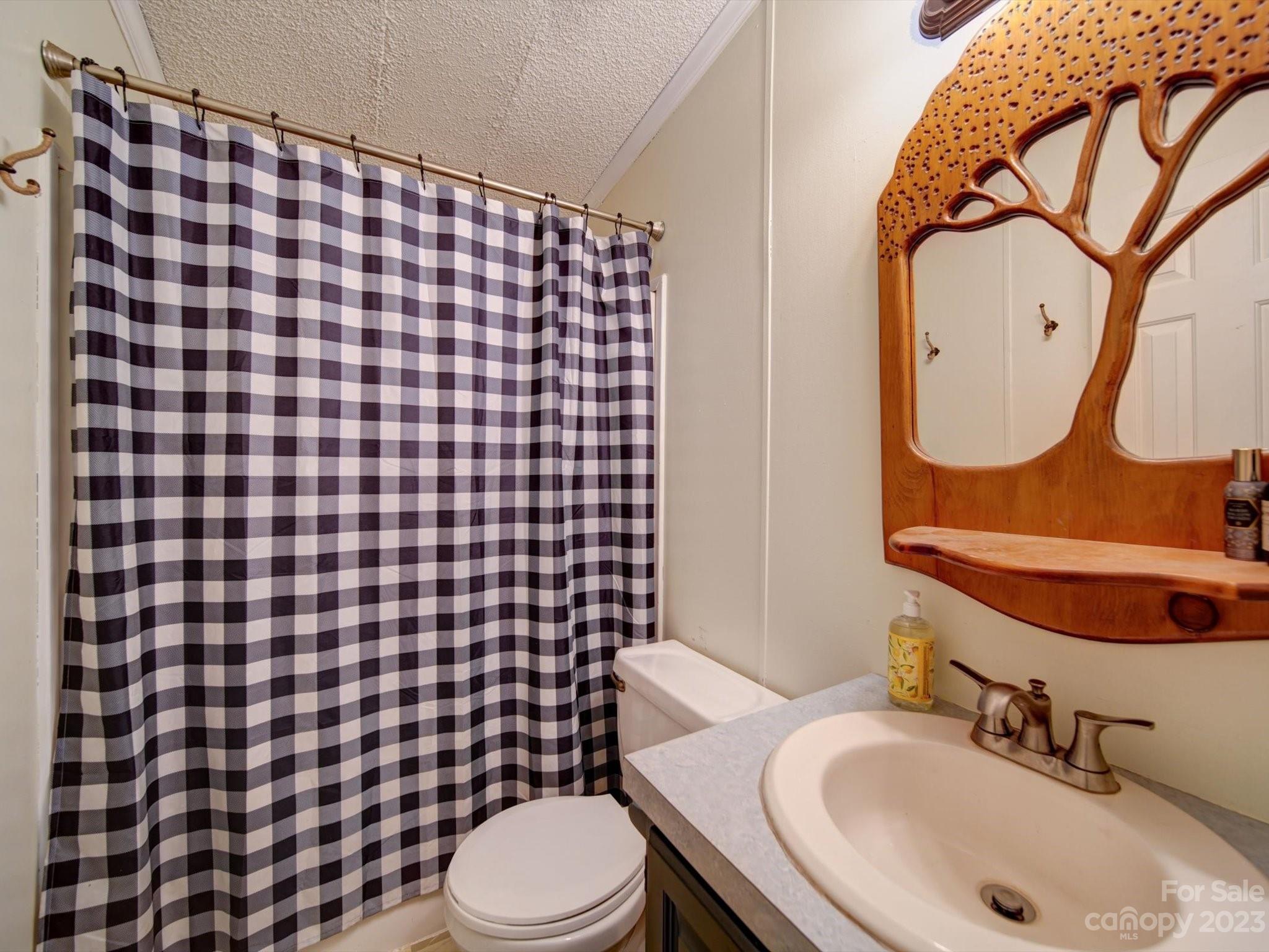 1265 Polk Ford Road Stanfield, NC 28163 - Photo 26 of 40 a bathroom with a sink toilet and shower