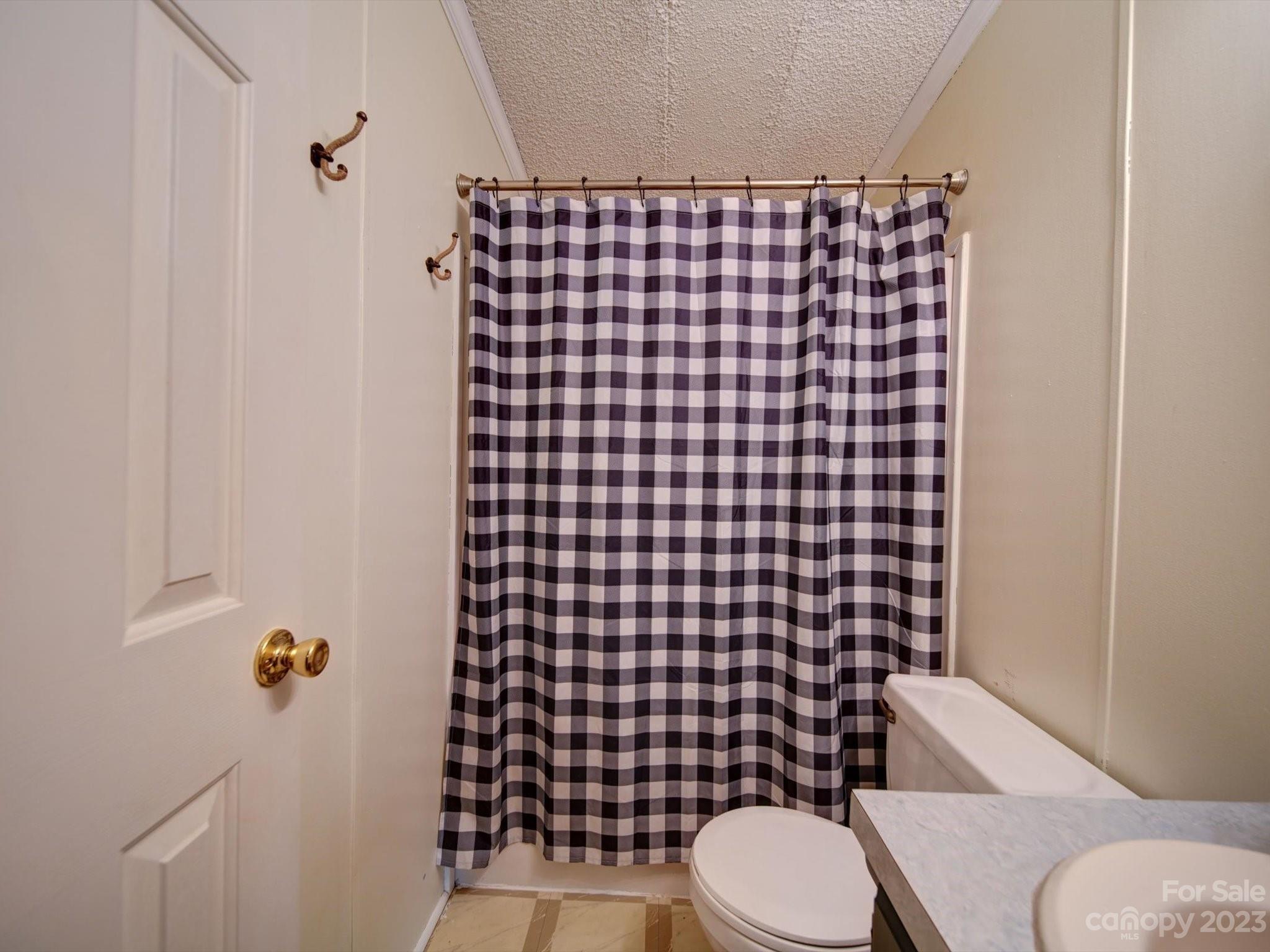 1265 Polk Ford Road Stanfield, NC 28163 - Photo 27 of 40 a bathroom with a toilet and a shower
