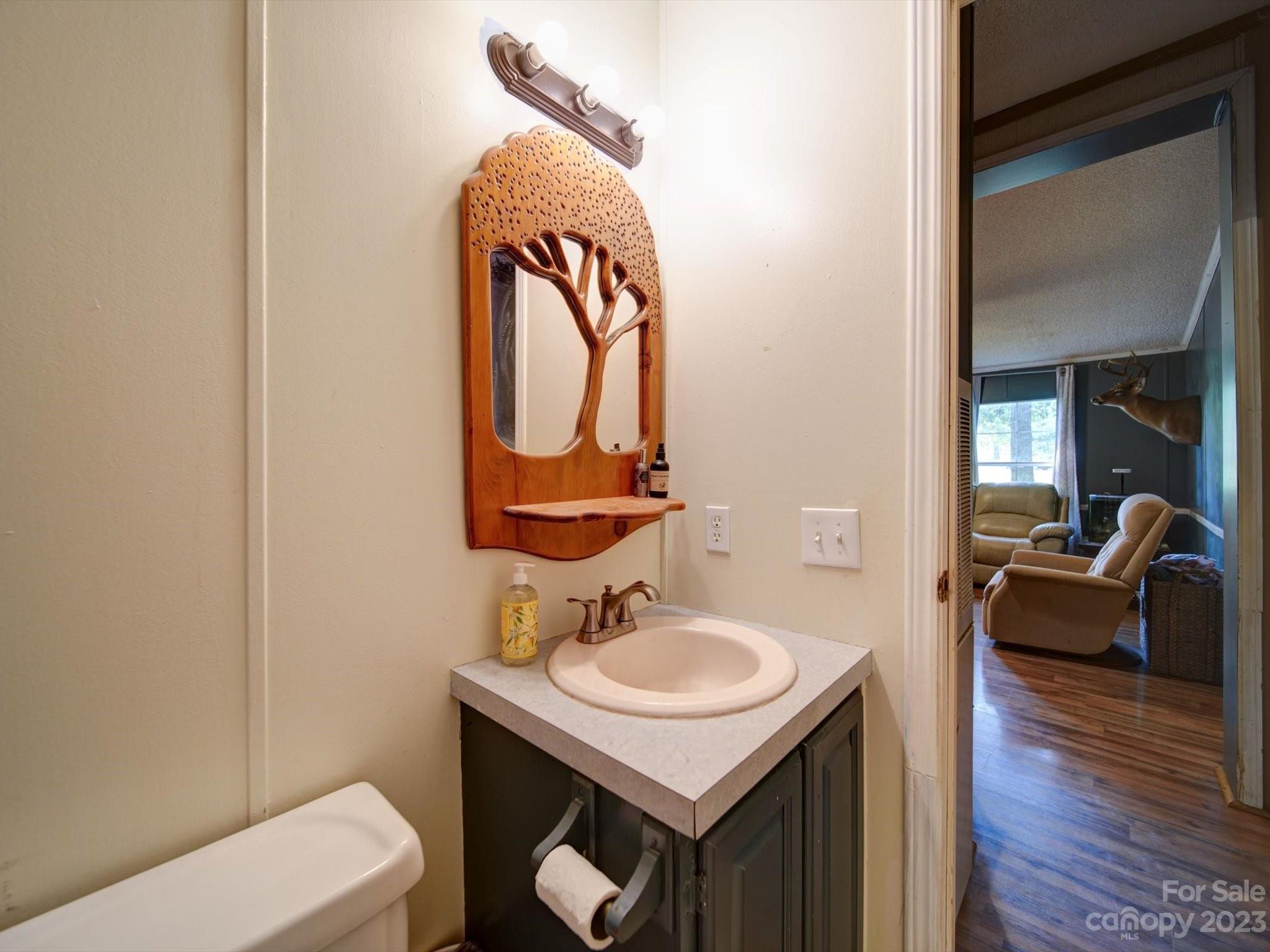 1265 Polk Ford Road Stanfield, NC 28163 - Photo 28 of 40 a bathroom with a sink toilet and vanity