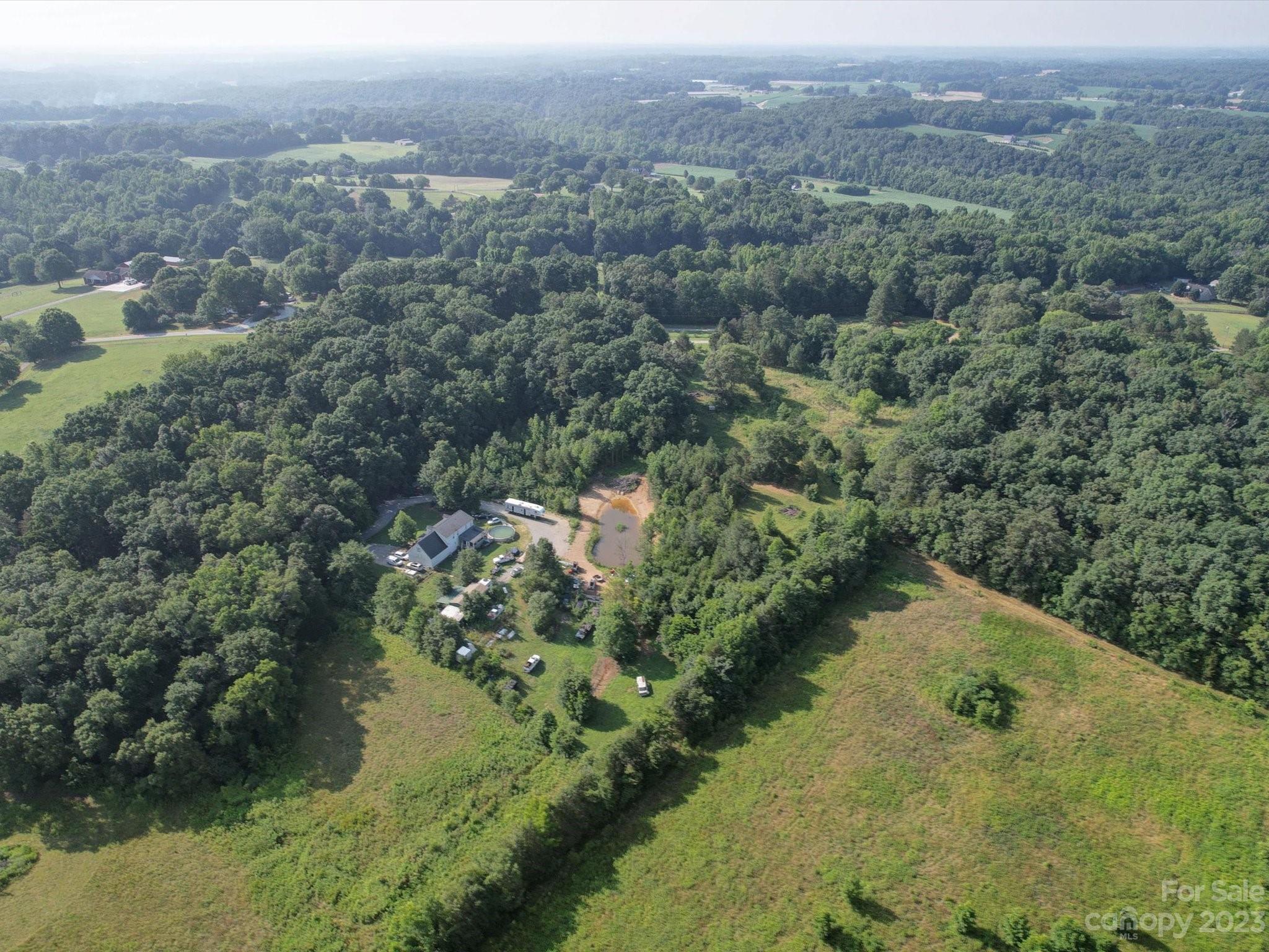1265 Polk Ford Road Stanfield, NC 28163 - Photo 3 of 40 an aerial view of mountain with residential house and lake view