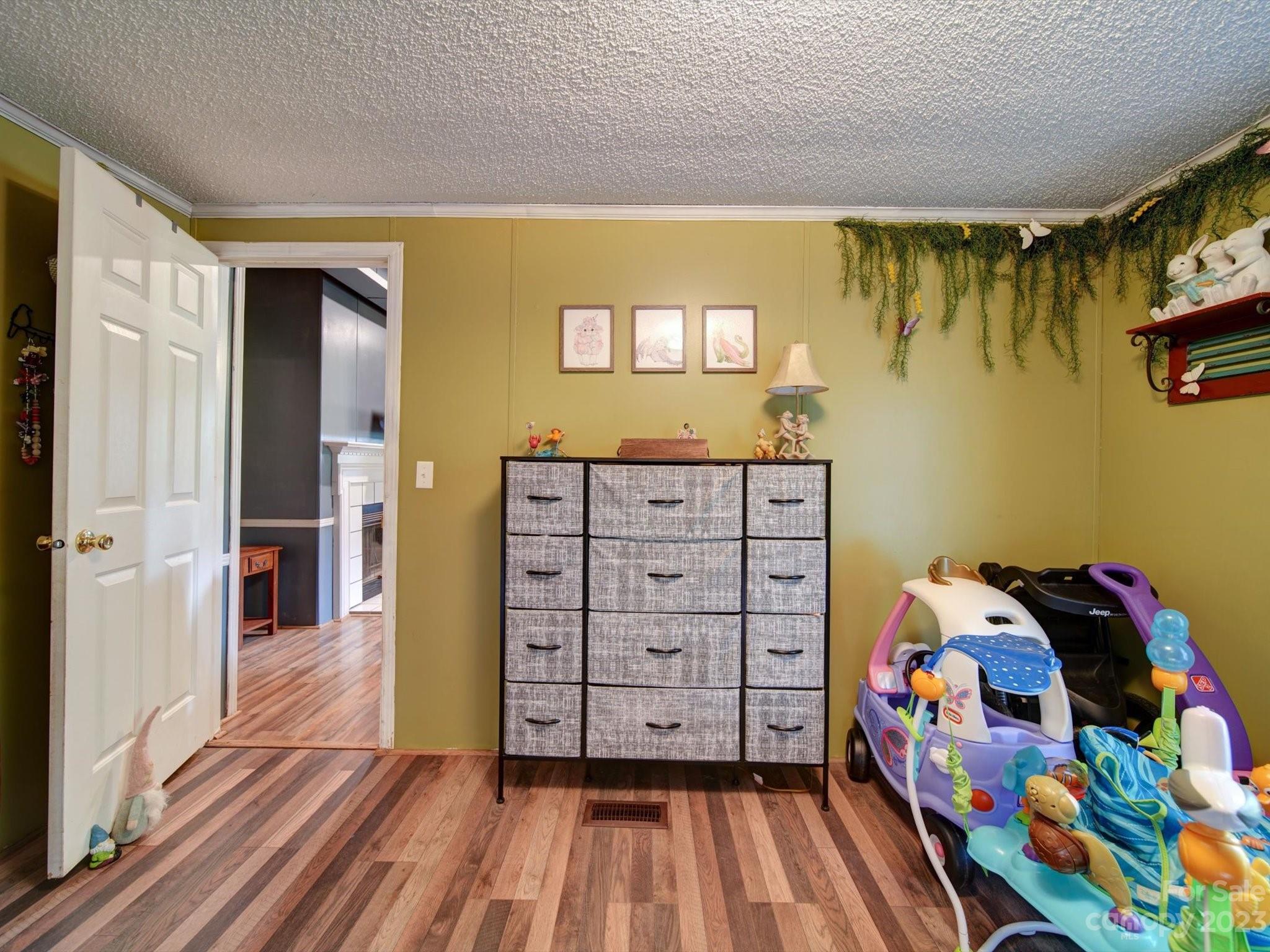 1265 Polk Ford Road Stanfield, NC 28163 - Photo 31 of 40 a view of a bedroom with toys and wooden floor