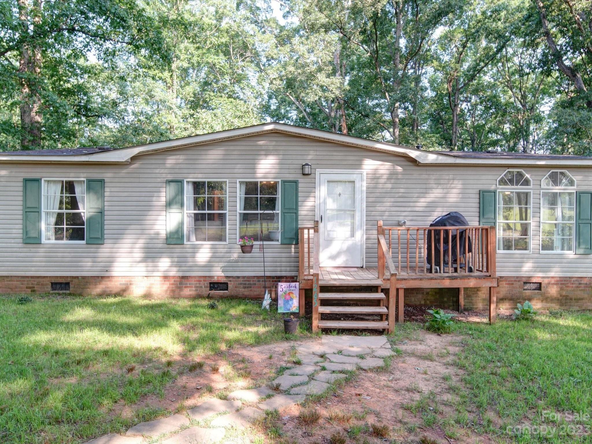 1265 Polk Ford Road Stanfield, NC 28163 - Photo 33 of 40 a front view of a house with a yard