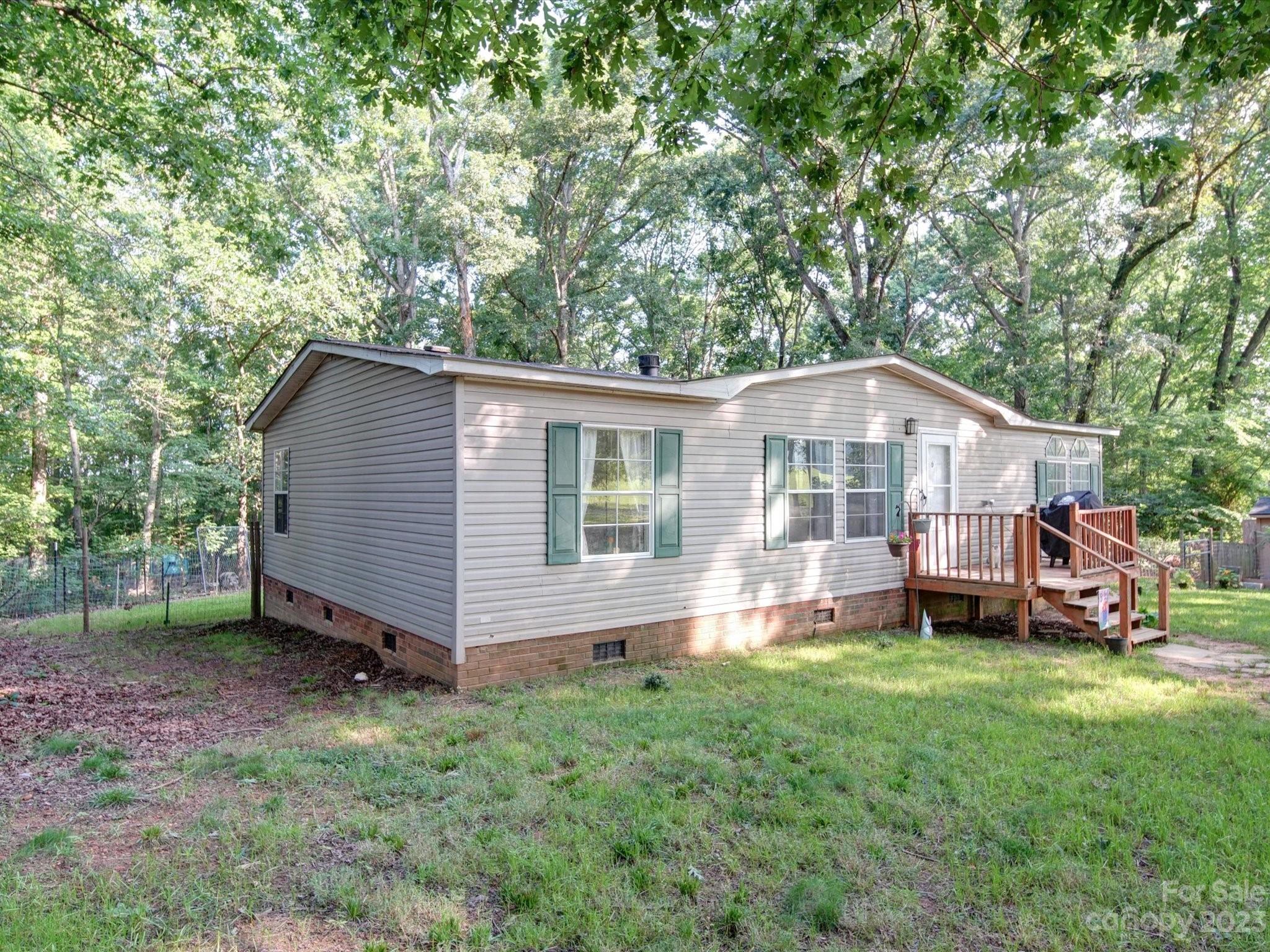 1265 Polk Ford Road Stanfield, NC 28163 - Photo 34 of 40 a view of a house with a yard and sitting area
