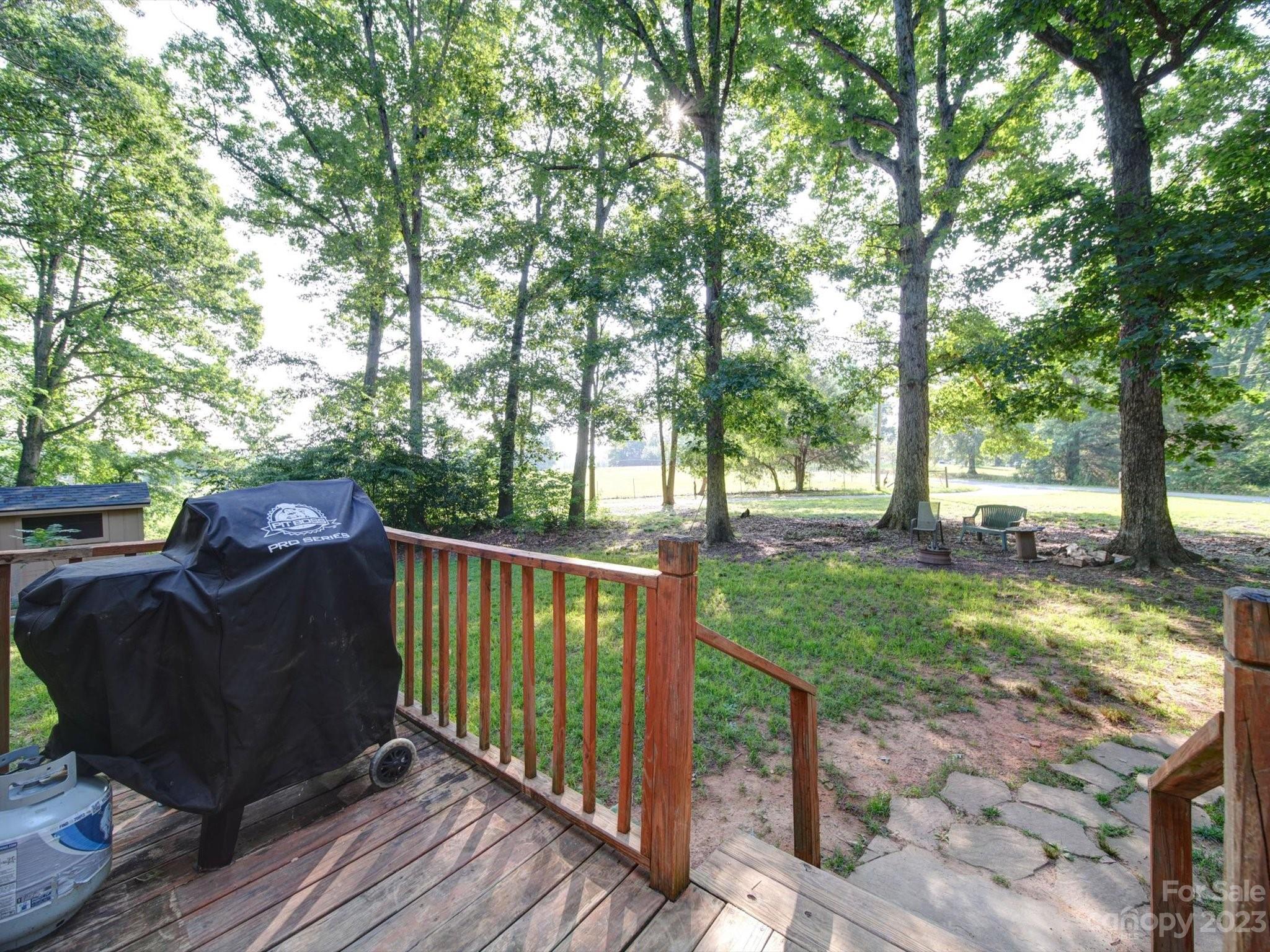 1265 Polk Ford Road Stanfield, NC 28163 - Photo 36 of 40 a view of a deck with a chair and floor to ceiling window