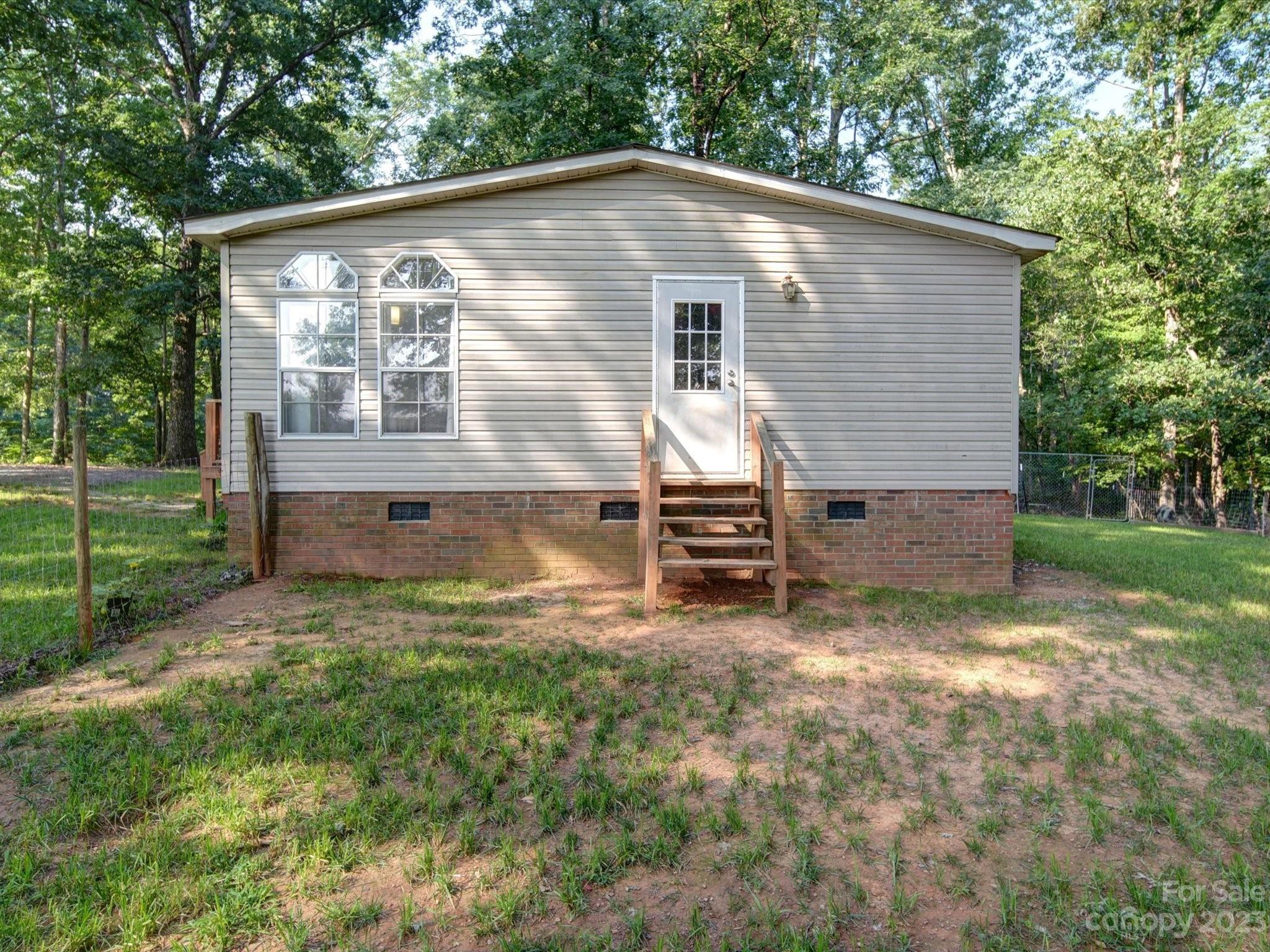 1265 Polk Ford Road Stanfield, NC 28163 - Photo 38 of 40 a front view of a house with a yard