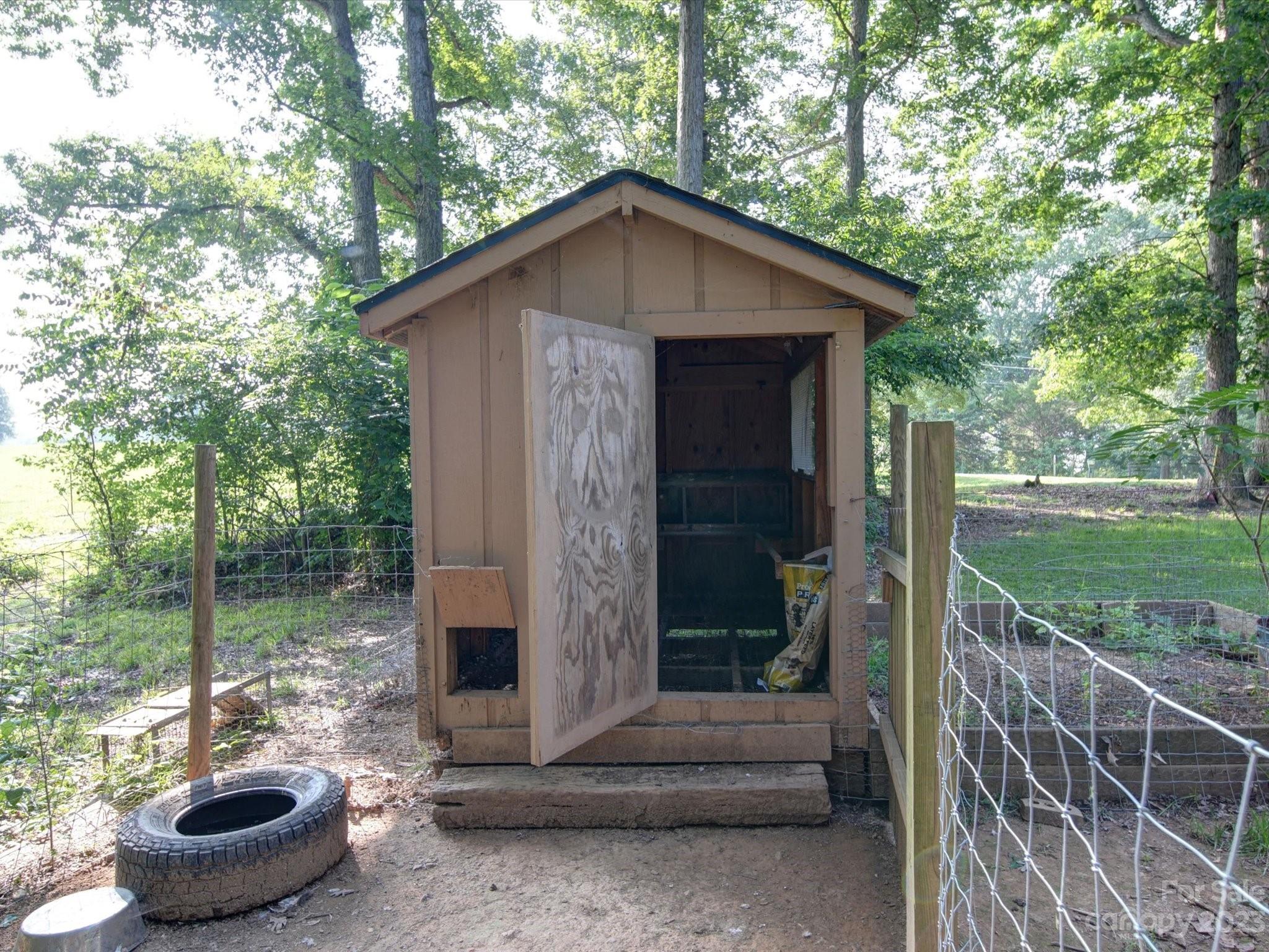 1265 Polk Ford Road Stanfield, NC 28163 - Photo 39 of 40 a backyard of a house with fountain table and chairs