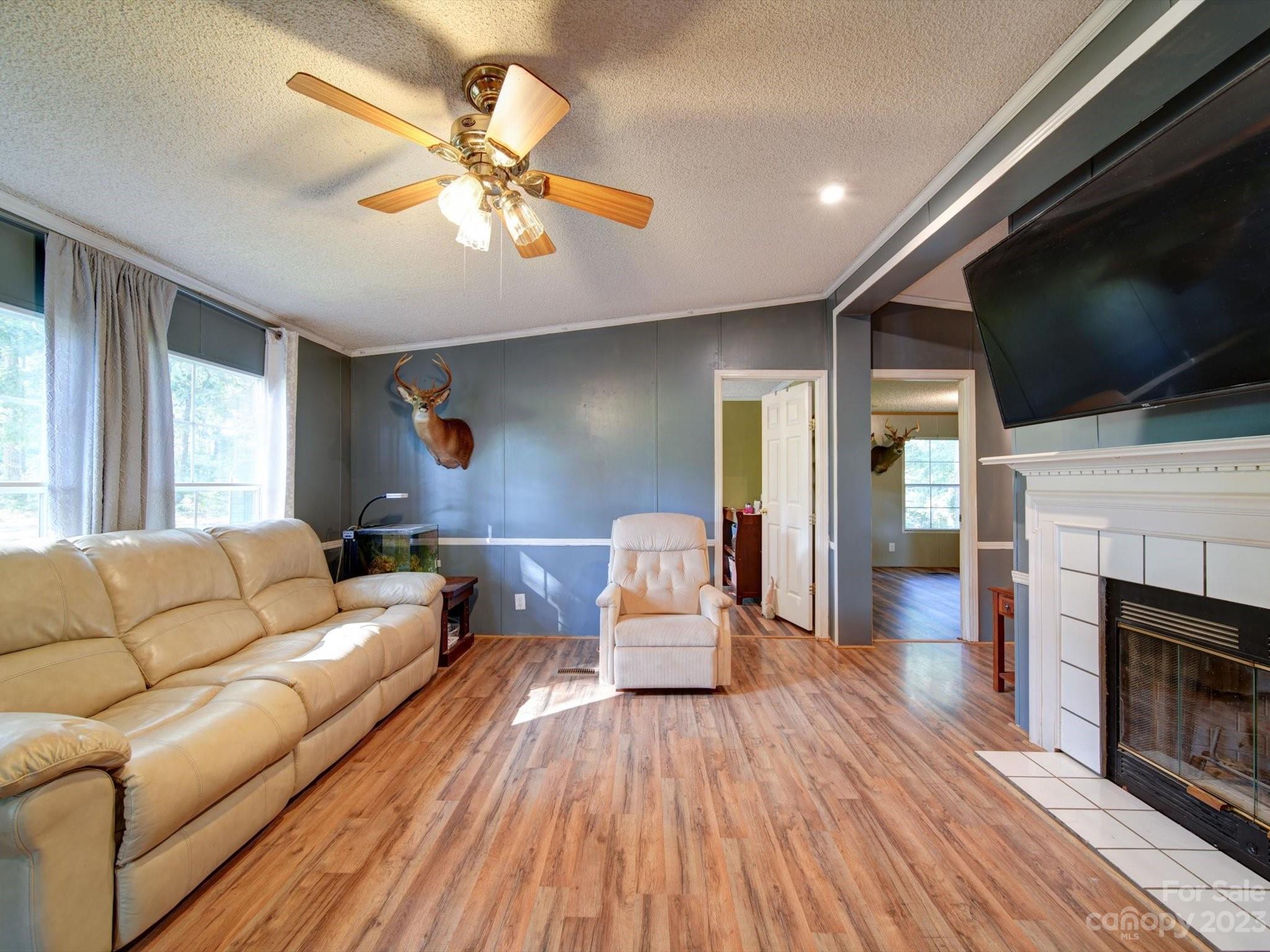 1265 Polk Ford Road Stanfield, NC 28163 - Photo 4 of 40 a living room with furniture and a flat screen tv