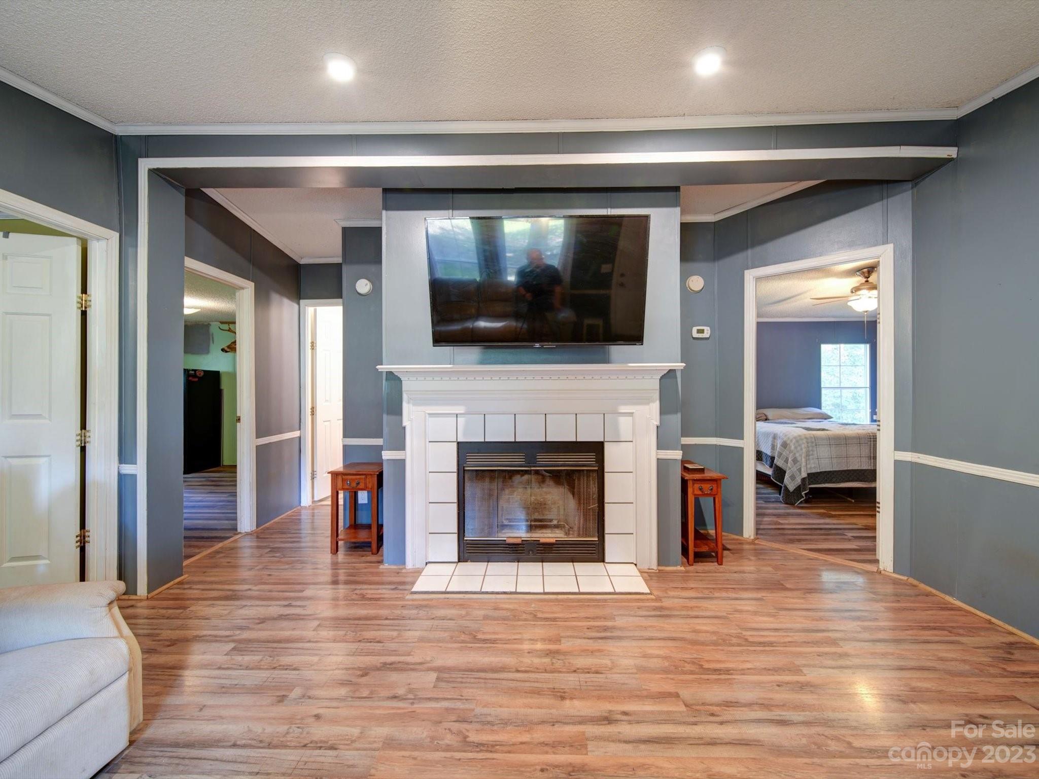 1265 Polk Ford Road Stanfield, NC 28163 - Photo 8 of 40 a living room with a flat screen tv and a fireplace
