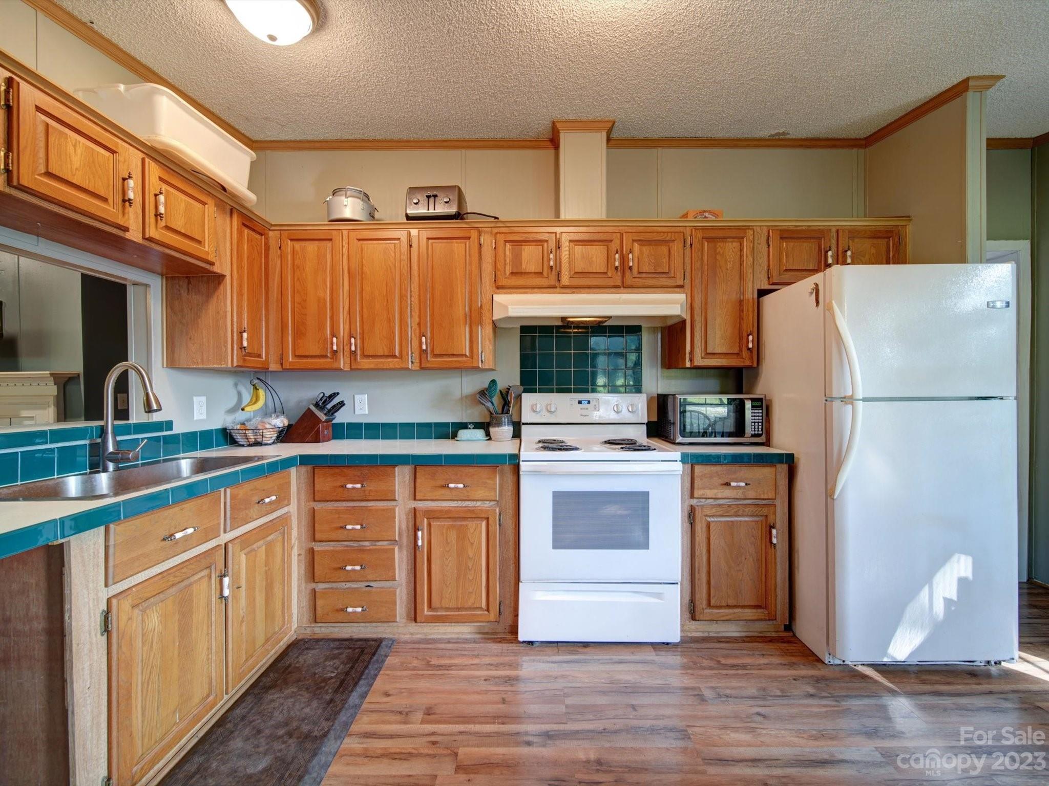 1265 Polk Ford Road Stanfield, NC 28163 - Photo 10 of 40 a kitchen with stainless steel appliances granite countertop a refrigerator sink and cabinets