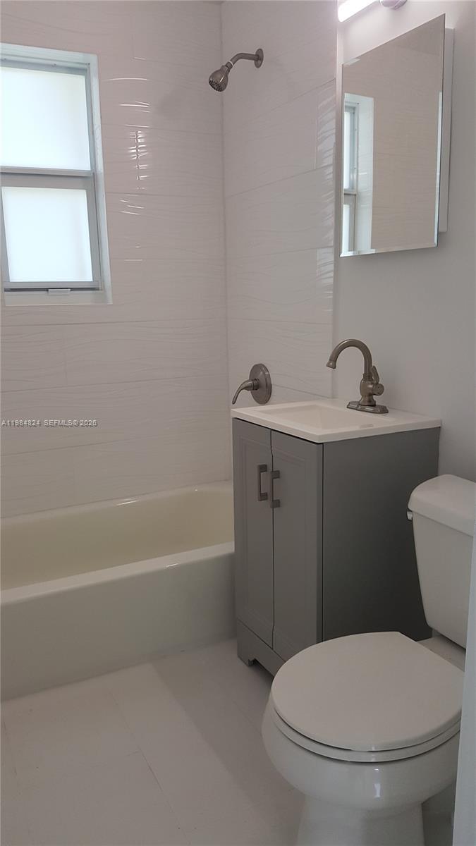 6300 Southwest 21st Street, Unit 1 Miami, FL 33155 - Photo 12 of 33 a bathroom with a toilet a sink and bathtub