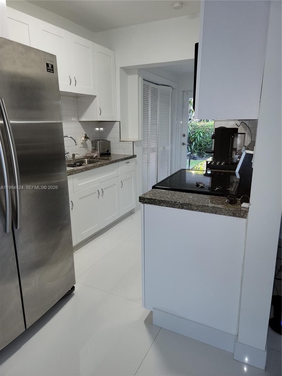 6300 Southwest 21st Street, Unit 1 Miami, FL 33155 - Photo 19 of 33 a kitchen with stainless steel appliances granite countertop a refrigerator and a sink