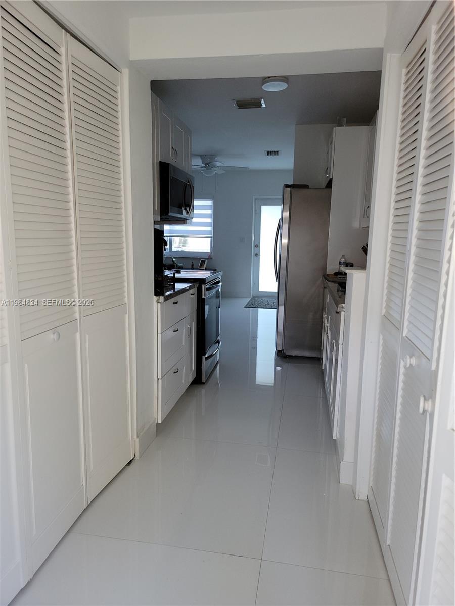 6300 Southwest 21st Street, Unit 1 Miami, FL 33155 - Photo 20 of 33 a view of a kitchen with a refrigerator a stove top oven and a refrigerator
