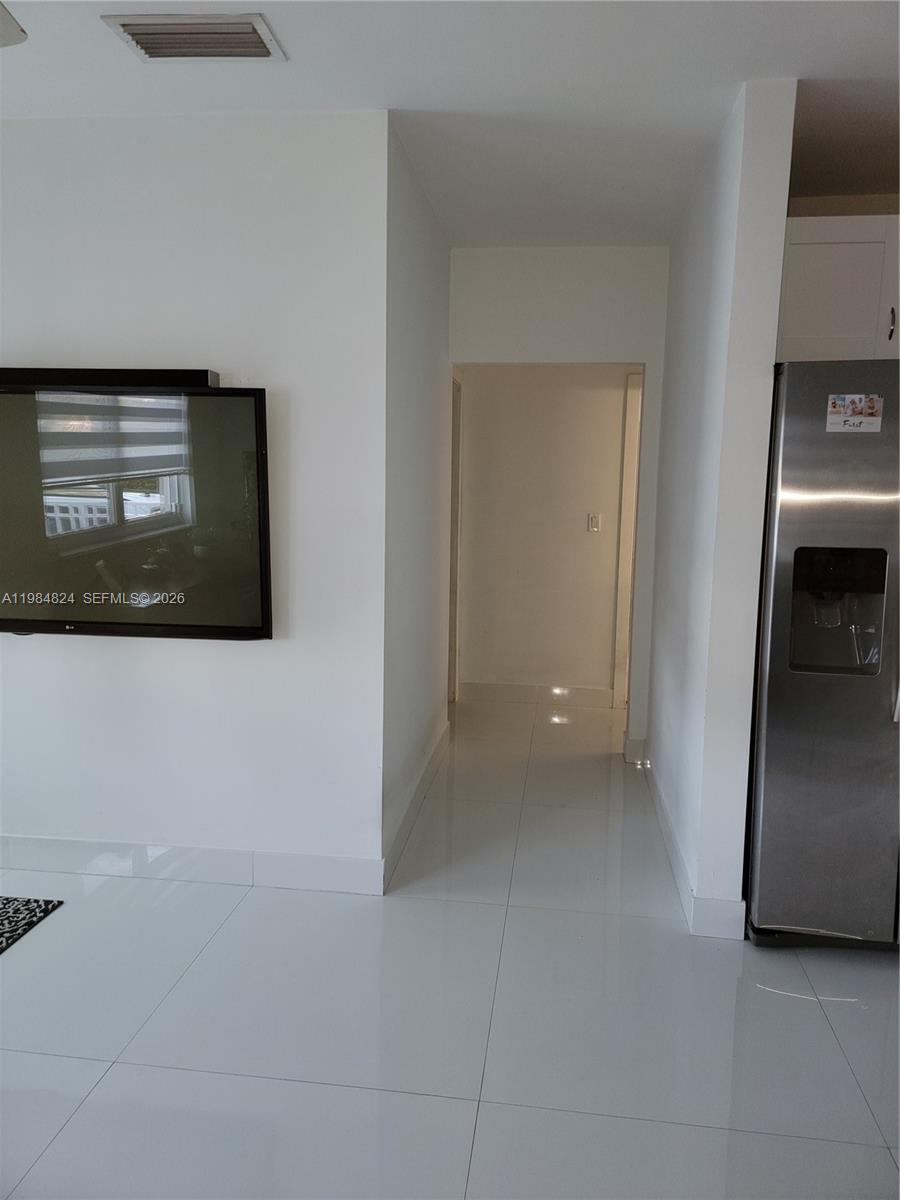 6300 Southwest 21st Street, Unit 1 Miami, FL 33155 - Photo 5 of 33 a view of a livingroom with an empty space and a fireplace