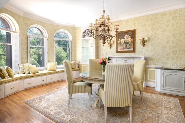 a view of a dining room with furniture a chandelier and wooden floor