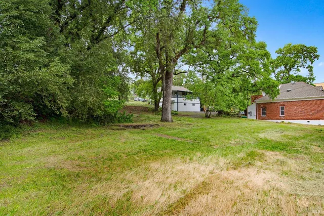 a view of house with backyard