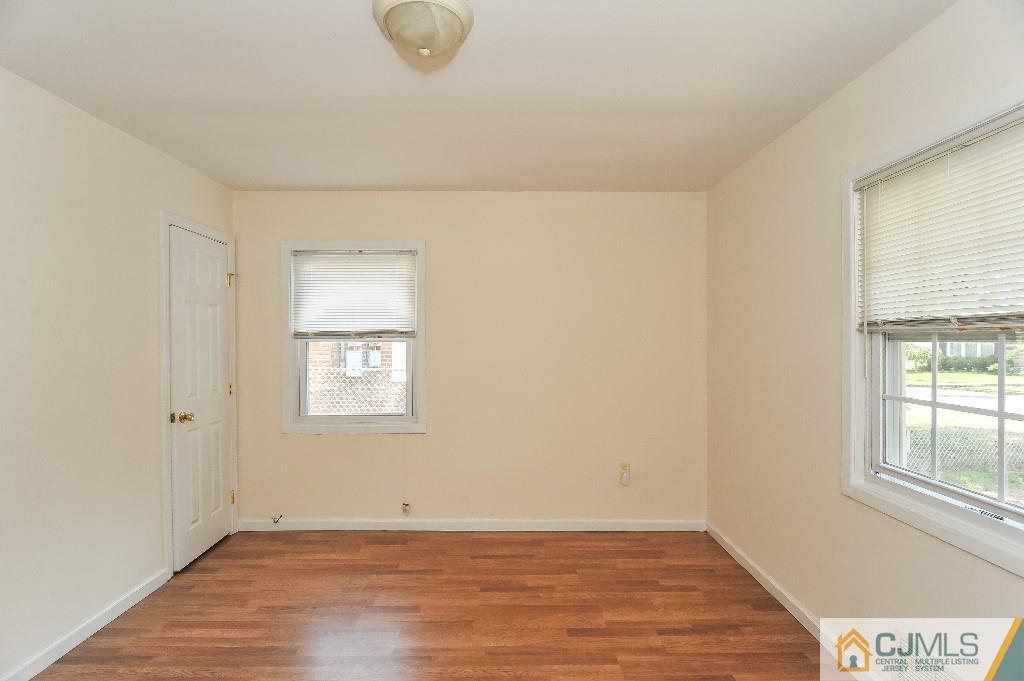 20 Stevens Road Edison, NJ 08817 - Photo 12 of 22 an empty room with wooden floor and windows