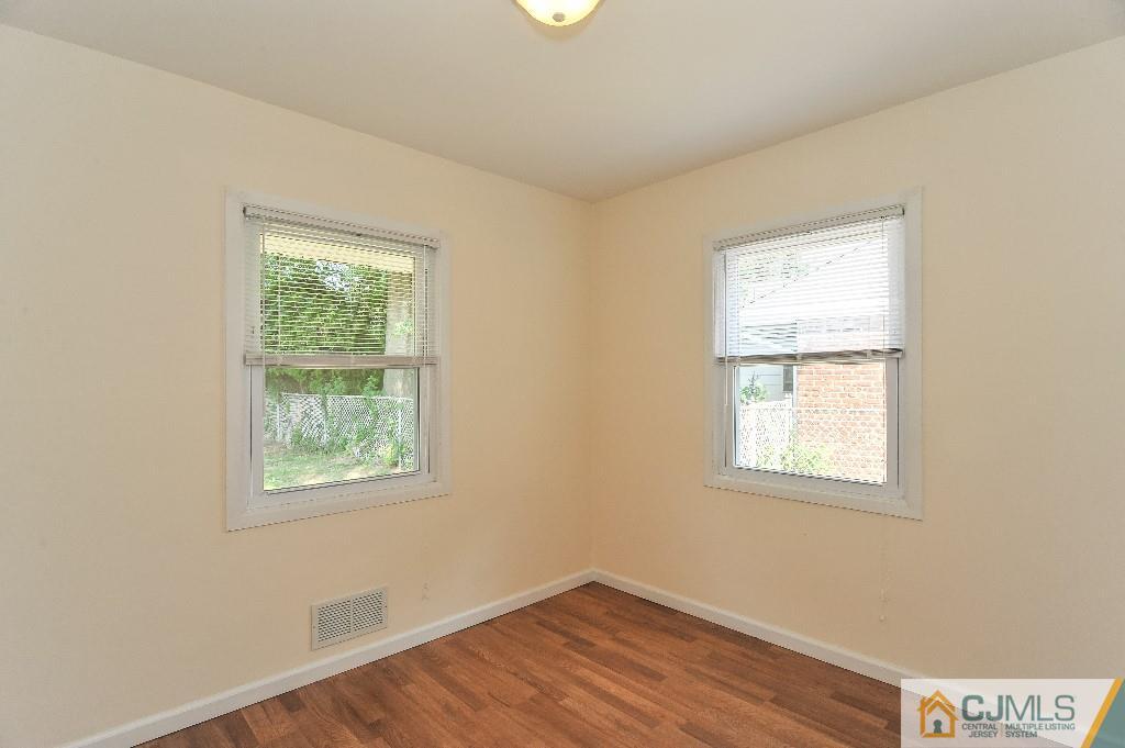 20 Stevens Road Edison, NJ 08817 - Photo 13 of 22 an empty room with wooden floor and windows