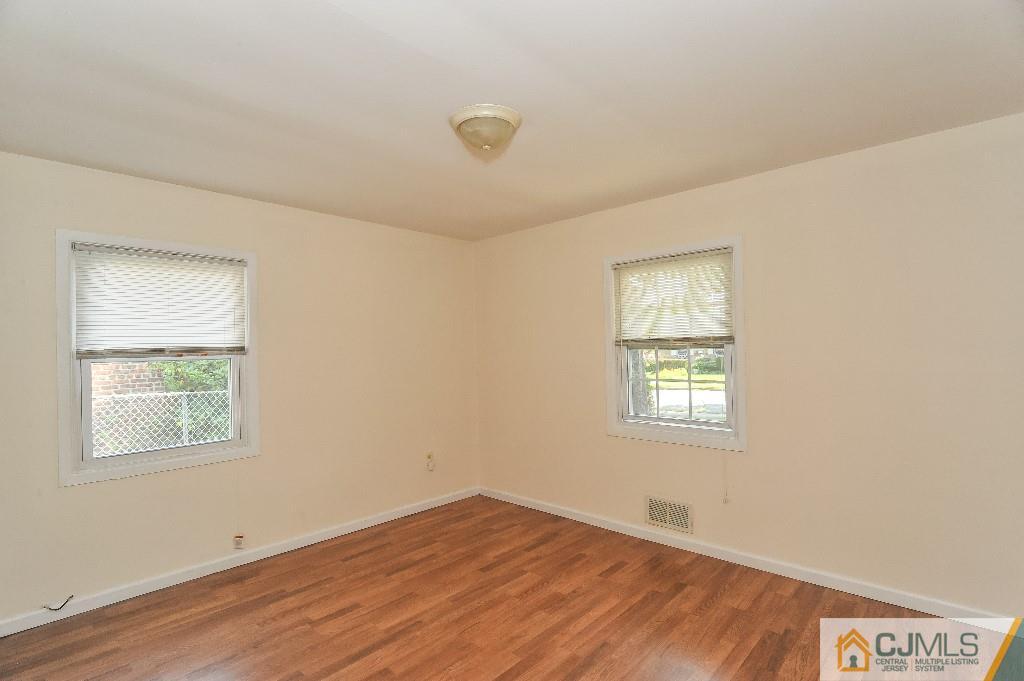 20 Stevens Road Edison, NJ 08817 - Photo 14 of 22 a view of an empty room with a window and wooden floor