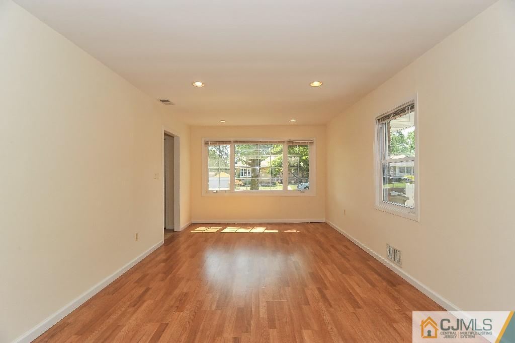 20 Stevens Road Edison, NJ 08817 - Photo 3 of 22 an empty room with wooden floor and windows