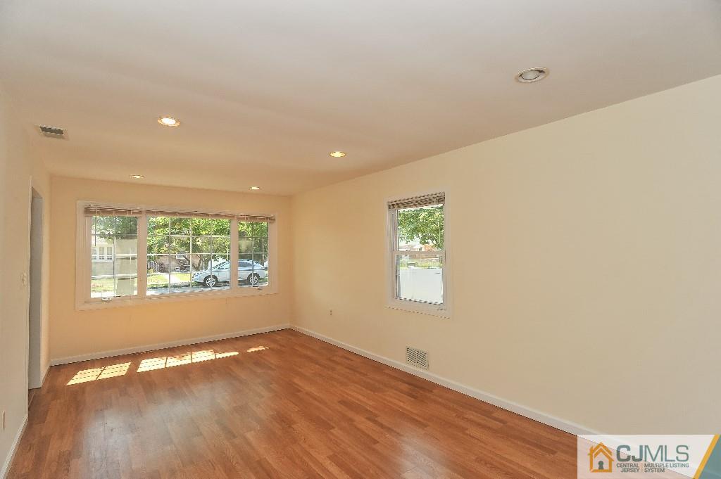 20 Stevens Road Edison, NJ 08817 - Photo 4 of 22 an empty room with wooden floor and windows