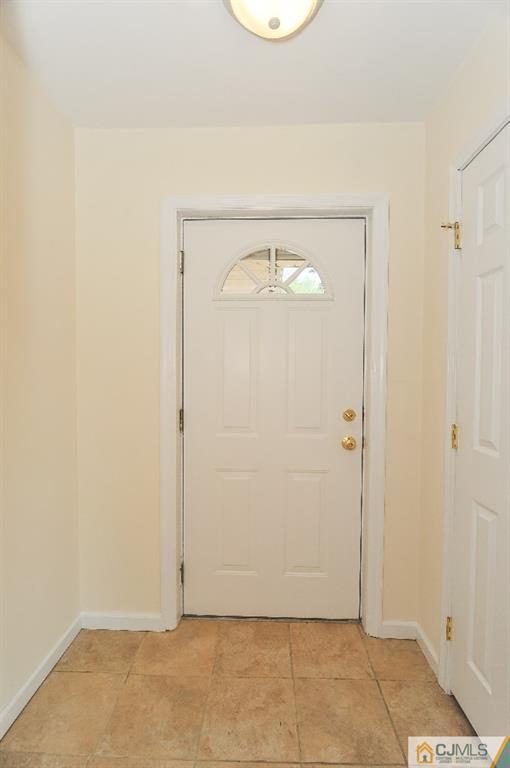 20 Stevens Road Edison, NJ 08817 - Photo 5 of 22 an empty room with wooden floor and mirror