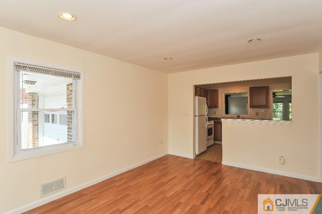 20 Stevens Road Edison, NJ 08817 - Photo 7 of 22 a view of empty room with wooden floor and kitchen