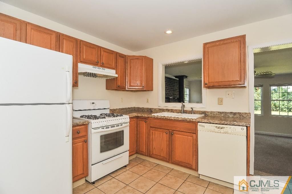 20 Stevens Road Edison, NJ 08817 - Photo 8 of 22 a kitchen with a stove top oven sink and cabinets