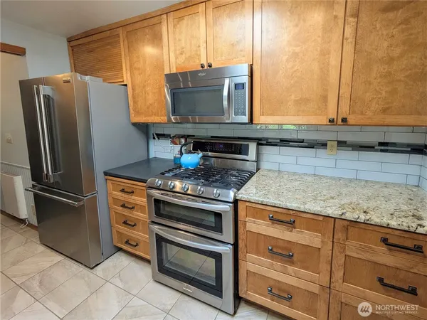 a stove top oven sitting inside of a kitchen
