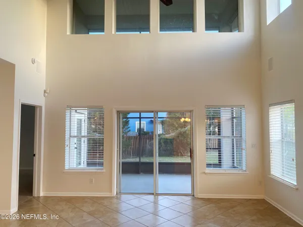 a view of an empty room with glass door