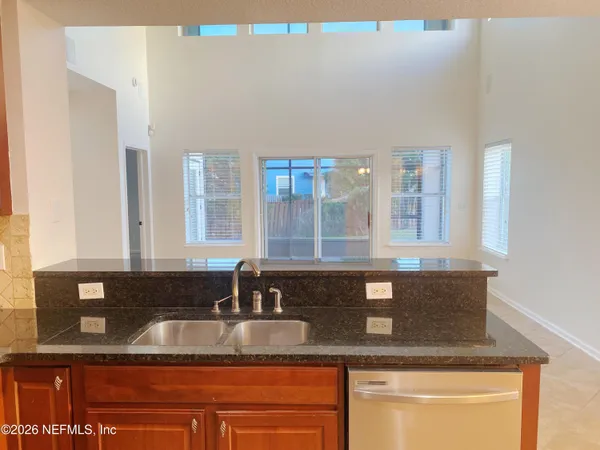 a kitchen with granite countertop a sink and a window