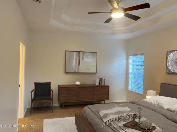 a bedroom with a bed and a chandelier