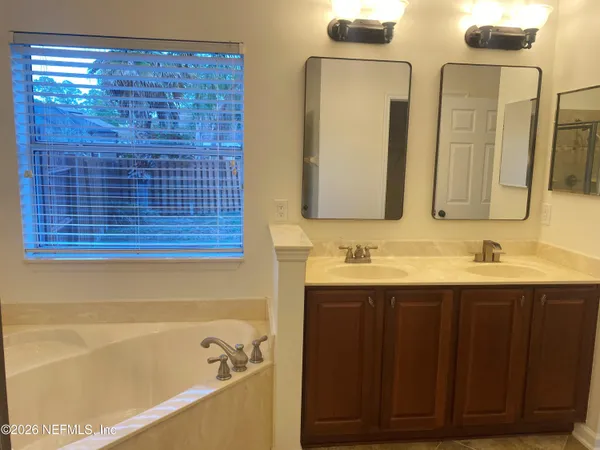 a bathroom with a bathtub and a sink