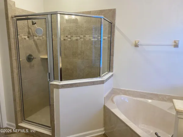 a bathroom with a bathtub and shower